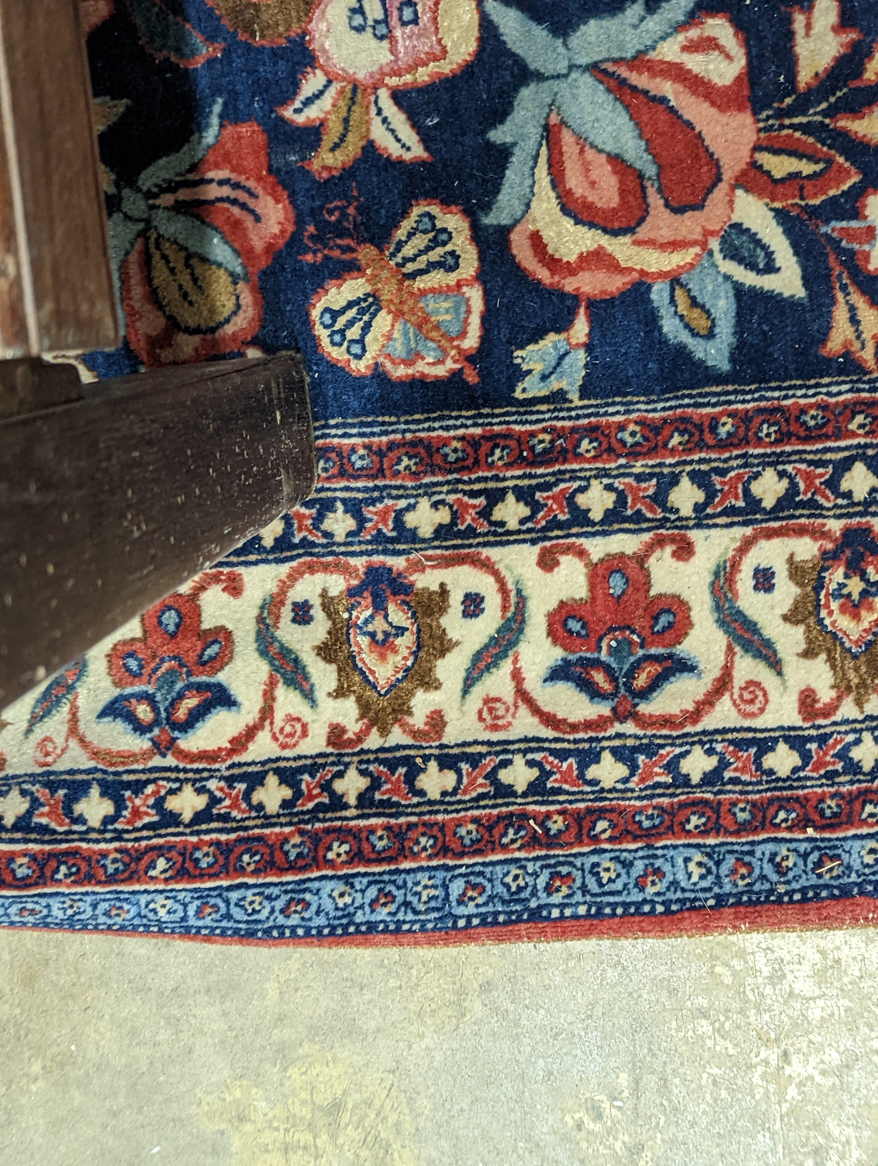 A Kirman blue ground rug woven with birds amongst flowering branches, 205 x 136cm